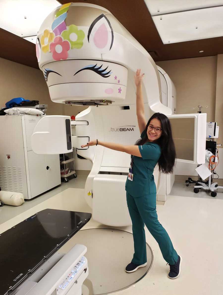 Photo of Adeline Li in front one of a machine she 