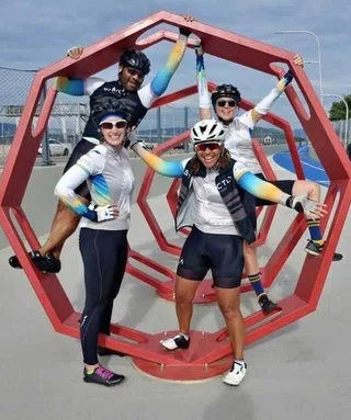 “Four Velocity Riders pose in their helmets and Ve